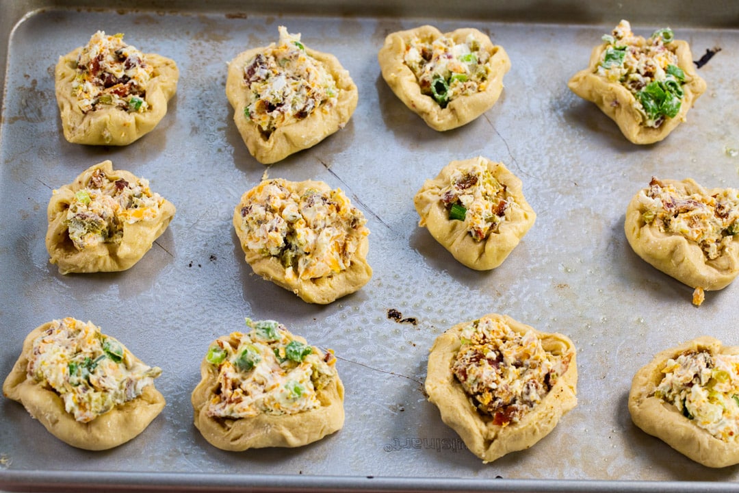 Unbaked biscuit rounds on baking sheet.