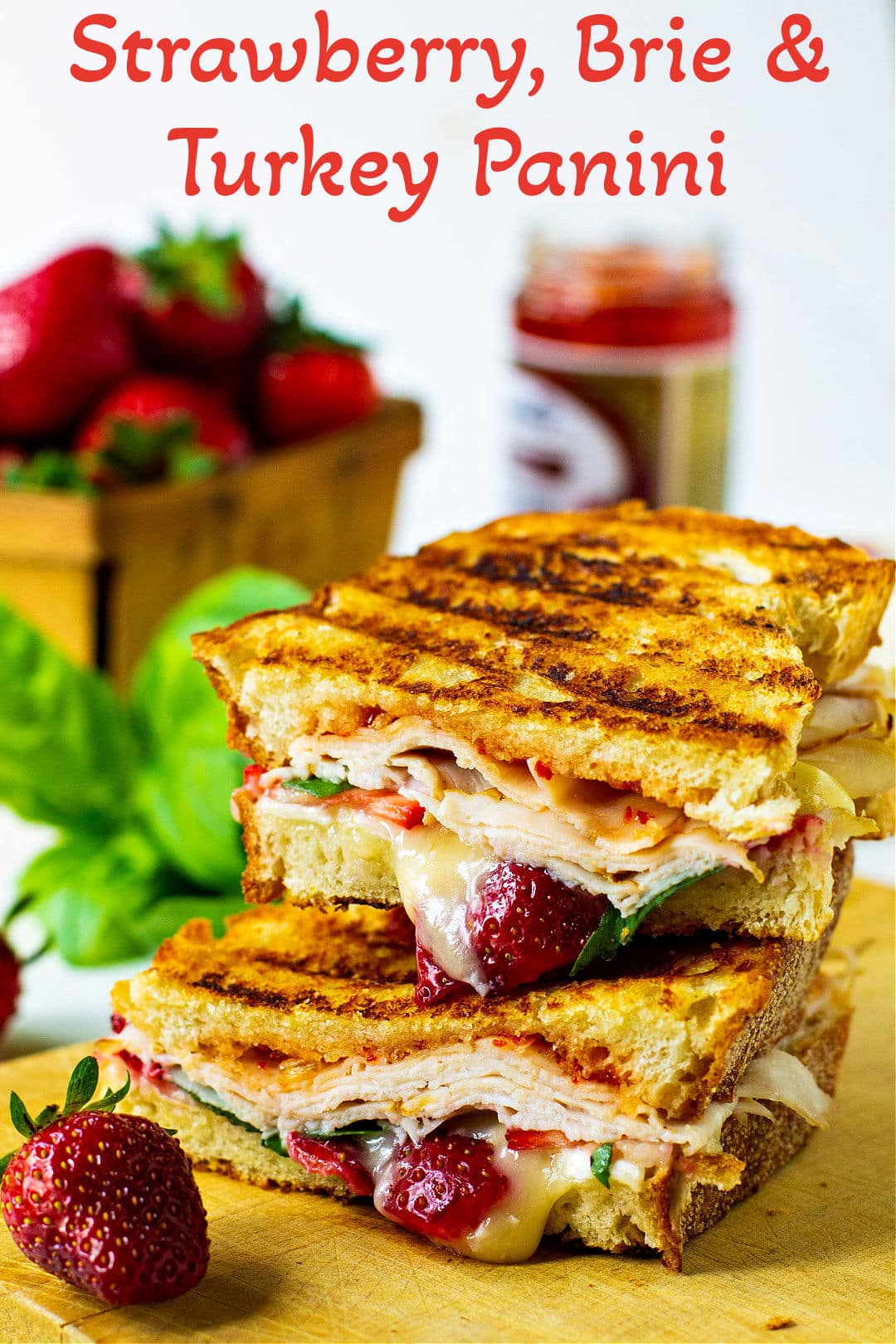 Panini cut in half on a cutting board.