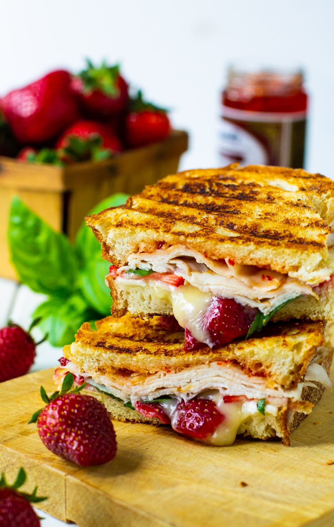 Strawberry, Brie, and Turkey Panini on cutting board.