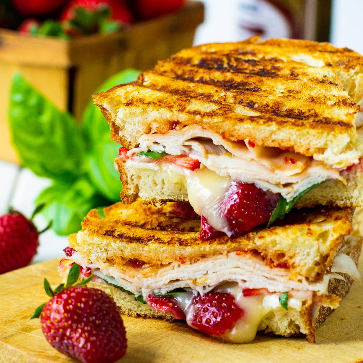 Strawberry, Brie, and Turkey Panini cut in half and stacked.
