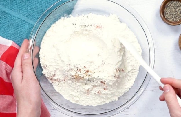 Mixing breading ingredients.