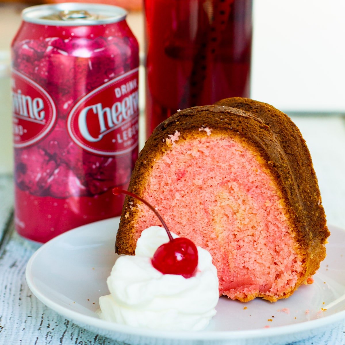Slice of Cheerwine Bundt Cake on a plate and a can of Cheerwine.