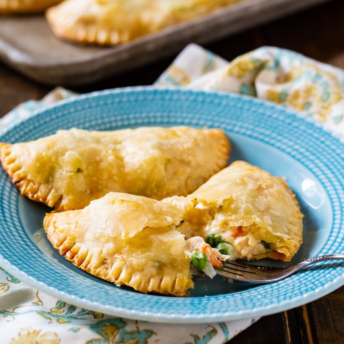 Two Chicken Pot Pie Turnovers on a plate.