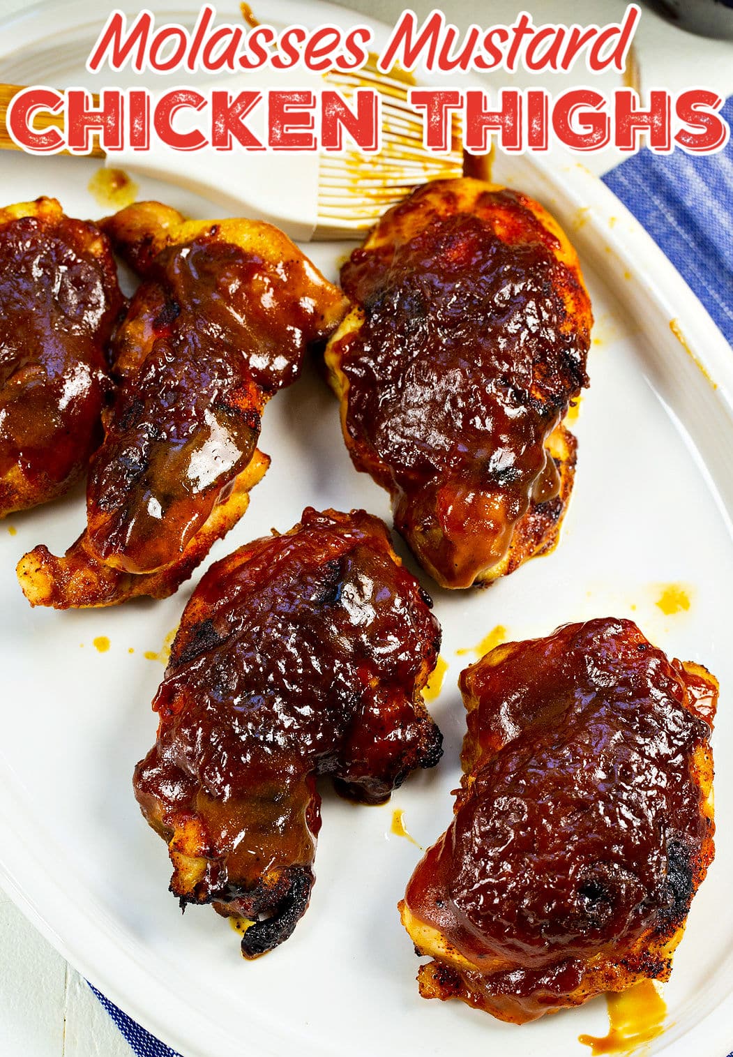 Cooked chicken with glaze on a serving plate.