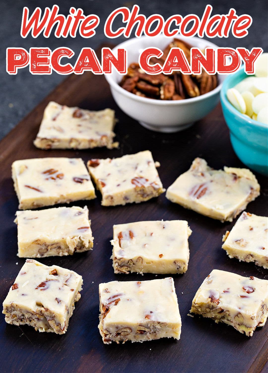 White Chocolate Pecan Candy squares on wooden board.