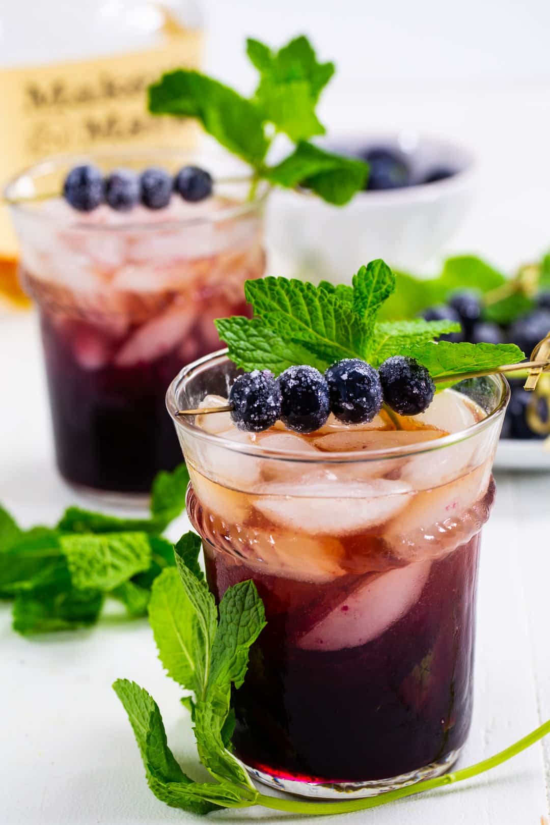 Mint Julep with blueberries in glasses.