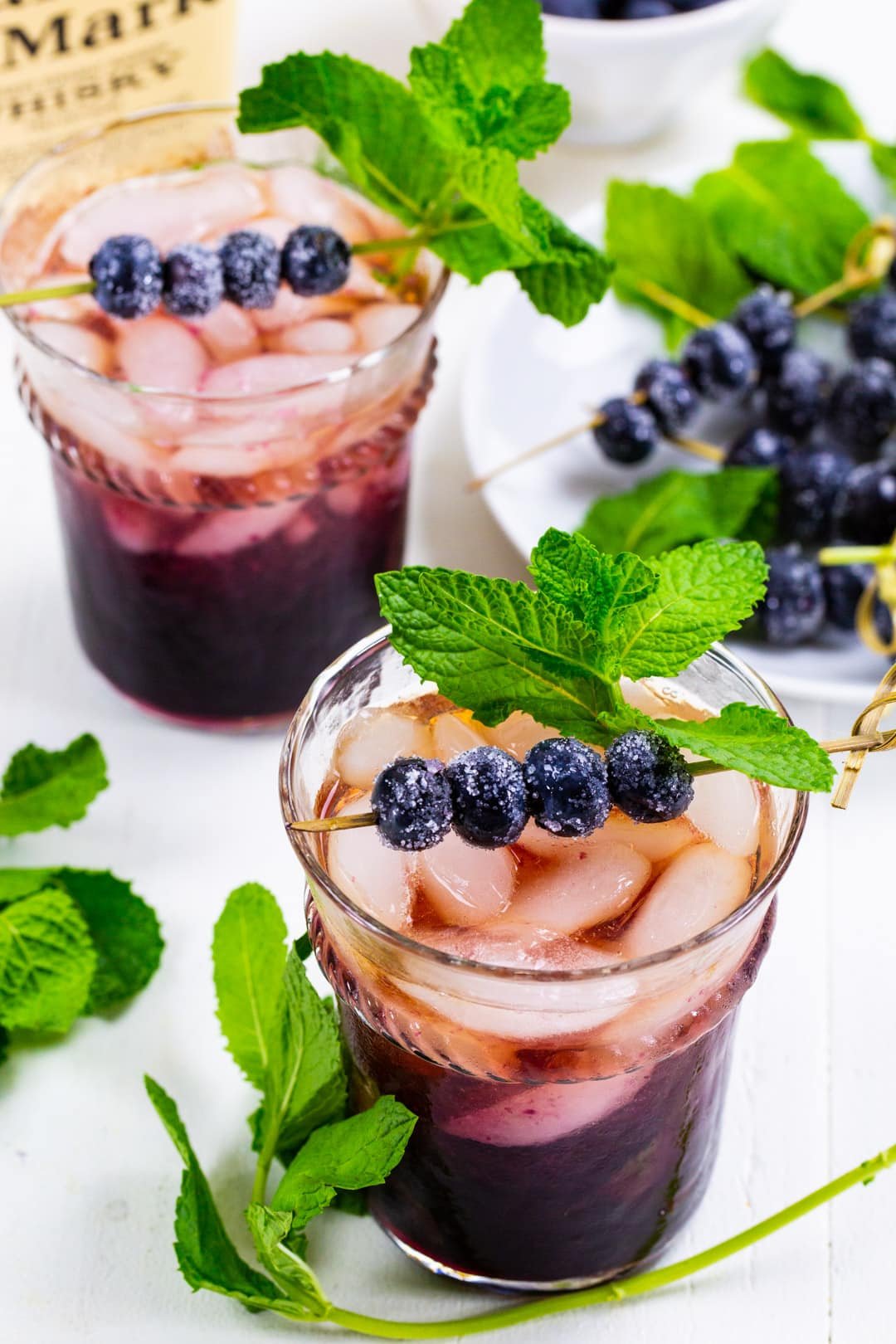 Two Blueberry Mint Juleps in glasses.