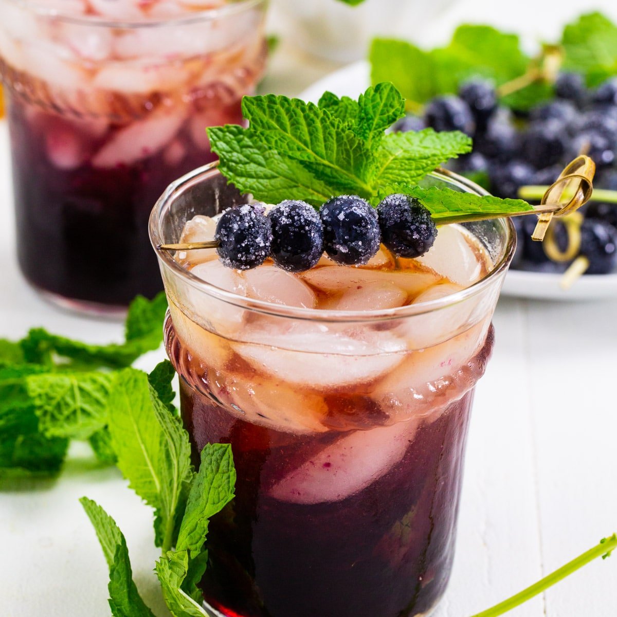 Blueberry Mint Julep in glass with mint and sugared blueberries.