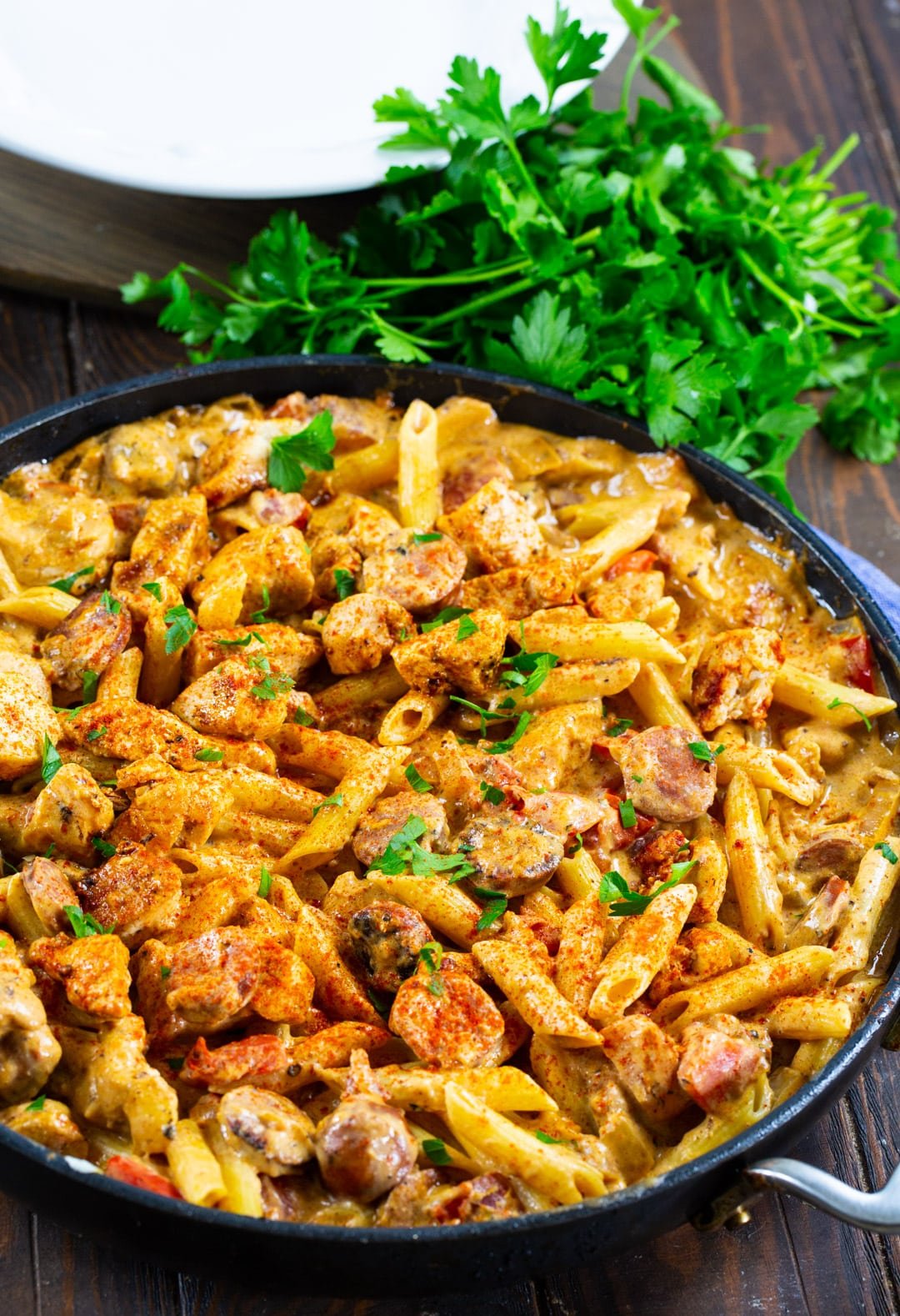 Chicken Pasta in skillet and a bunch of parsley.