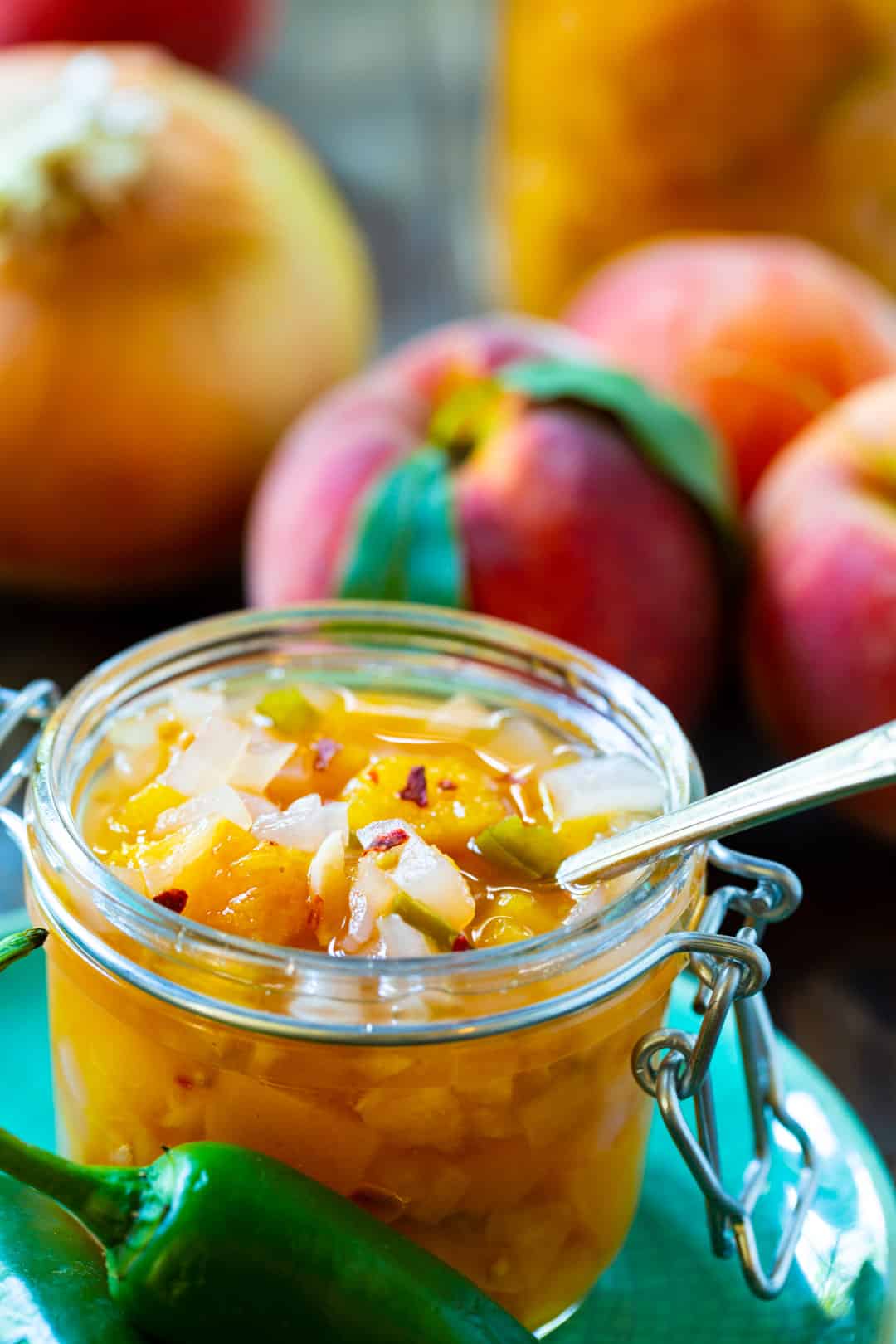 Relish in a glass jar with a spoon stuck in it.
