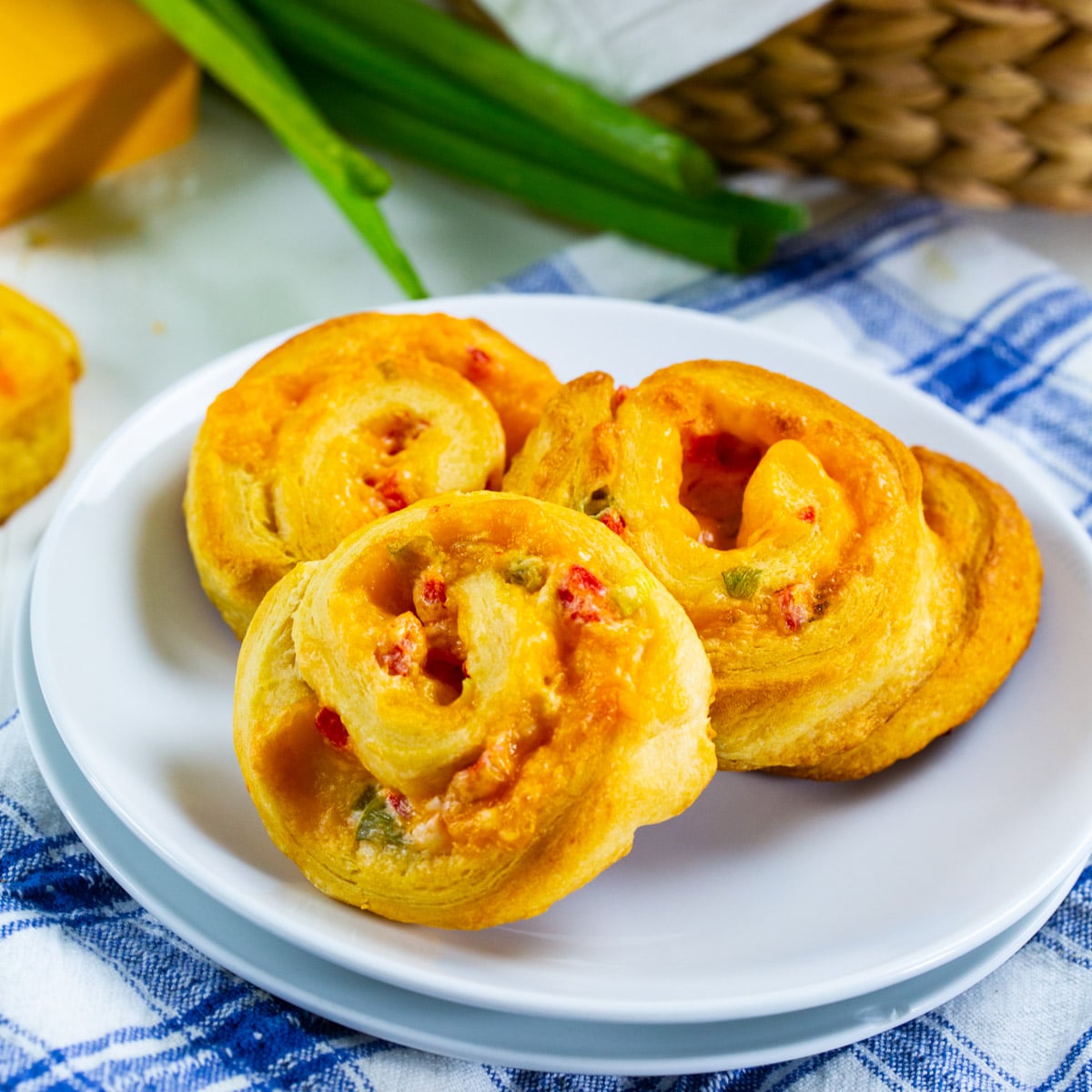 Three Pimento Cheese Spirals on a plate.