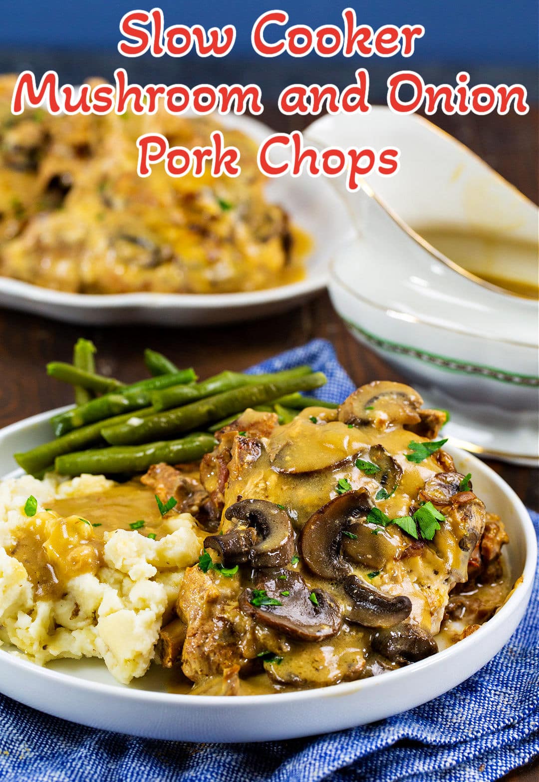Slow Cooker Mushroom and Onion Pork Chops dished up on plate with mashed potatoes and green beans.