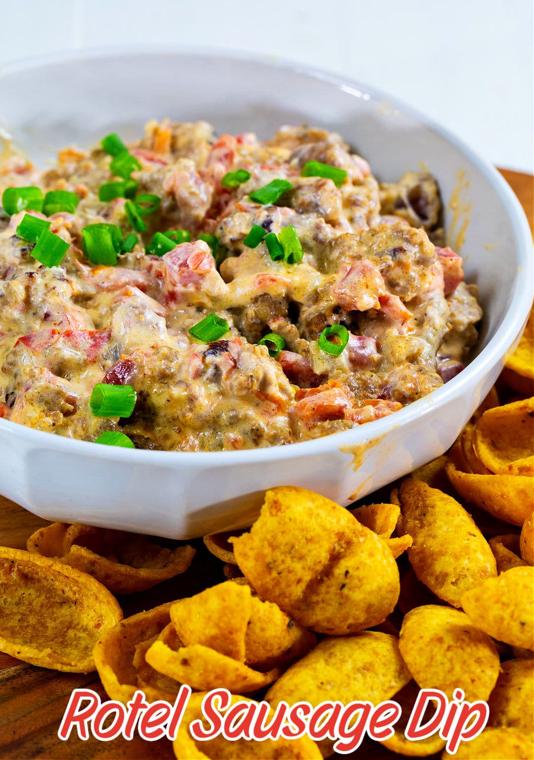 3-Ingredient Sausage Rotel Dip in a bowl surrounded by Frito chips.