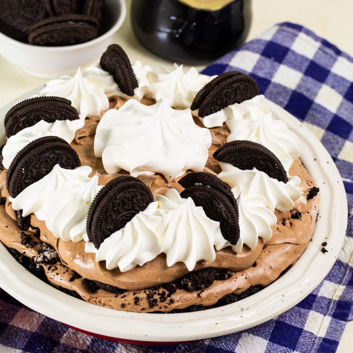 Whole Baileys Chocolate Cream Pie topped with whipped cream and oreo cookies.