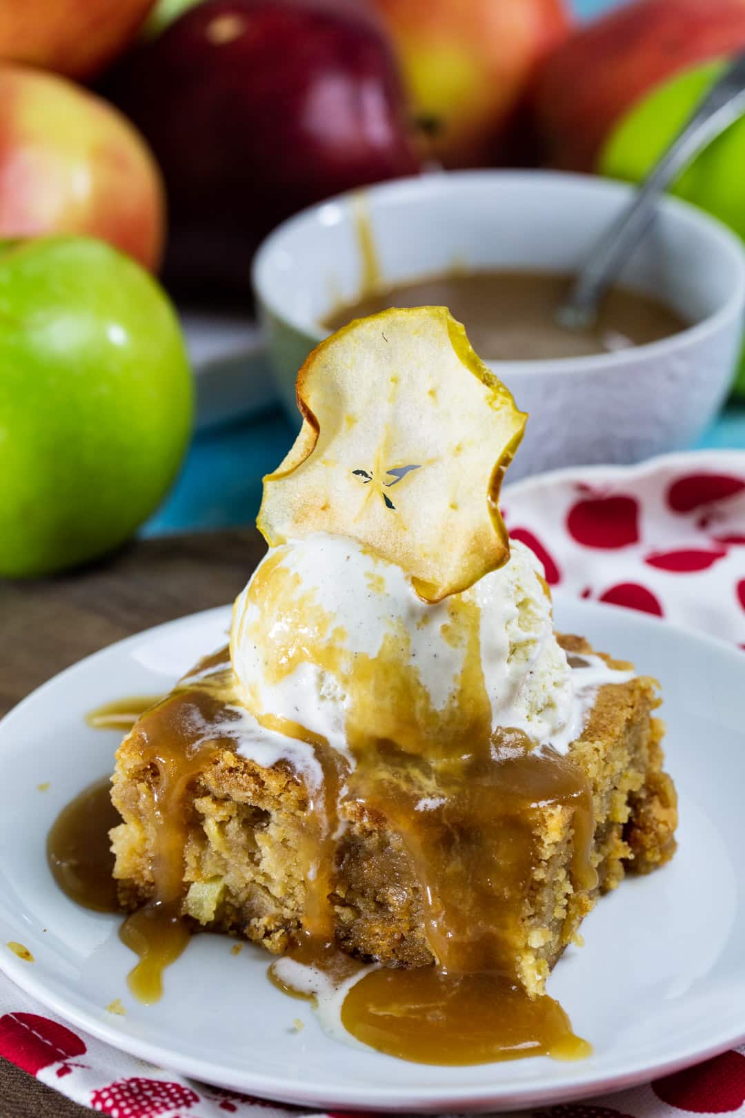 Butterscotch Apple Bar topped with ice cream and caramel sauce on a plate.