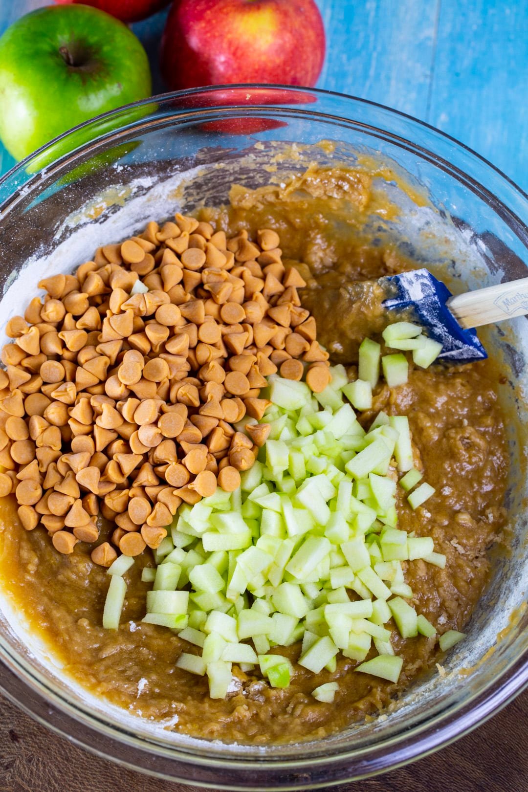 Batter, diced apple, and butterscotch chips in a mixing bowl.