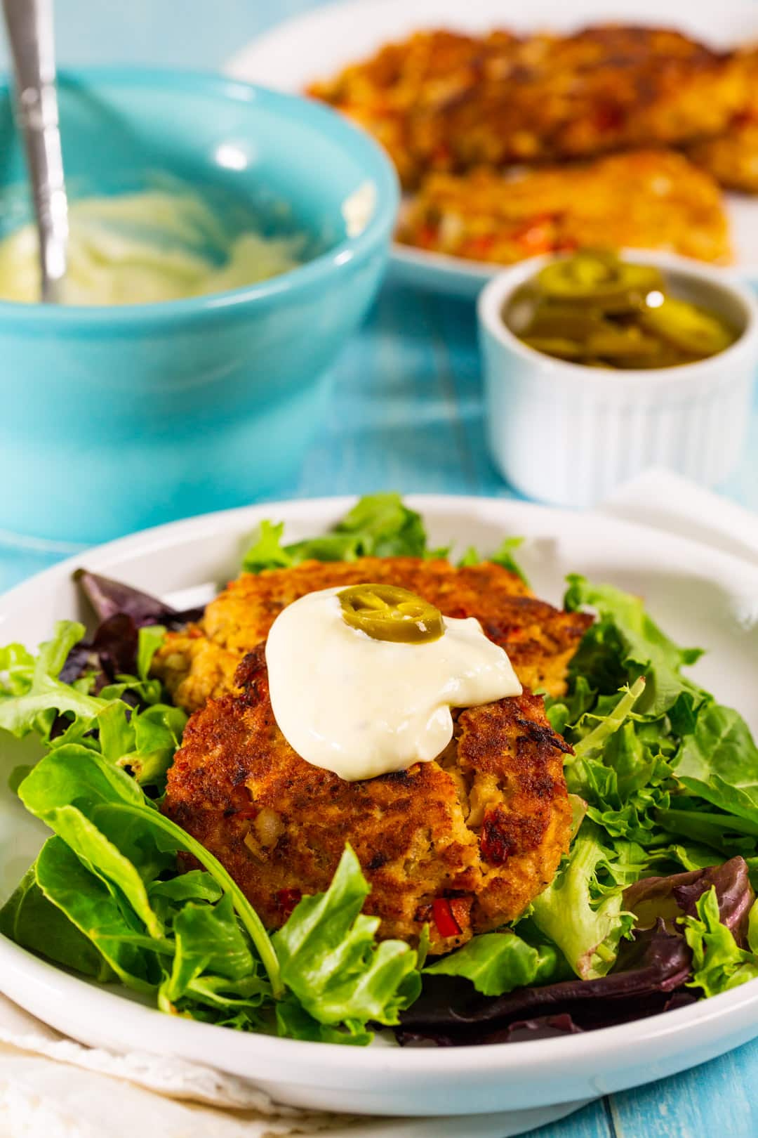 Salmon patties on a bed of mixed greens