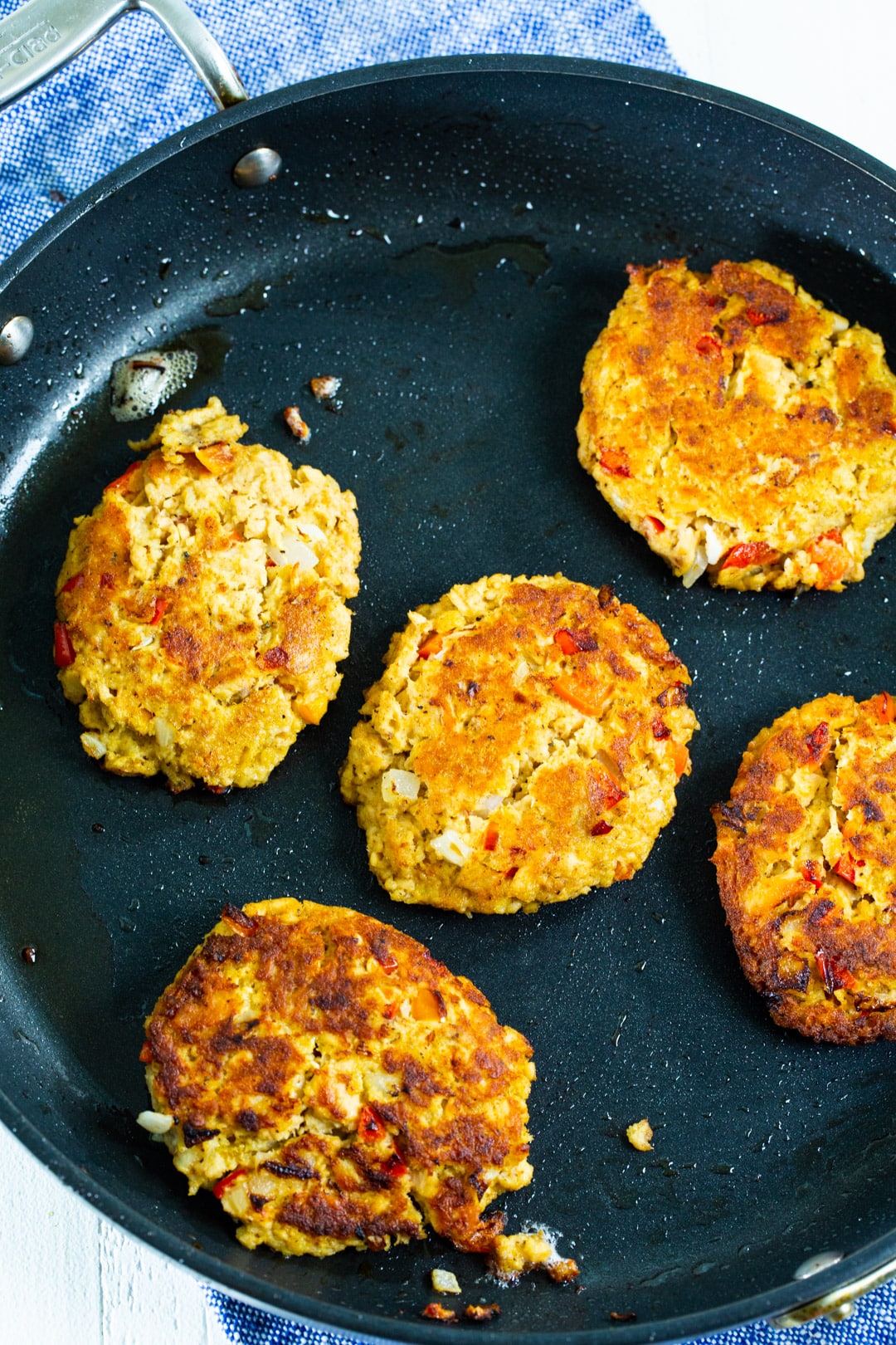 Salmon cakes in a skillet.