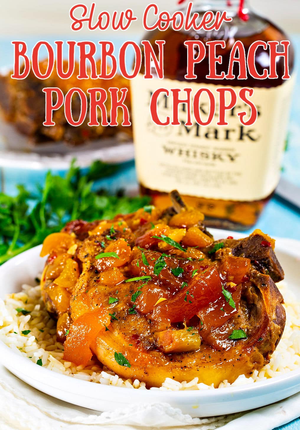Slow Cooker Bourbon Peach Pork Chops over rice on a plate.