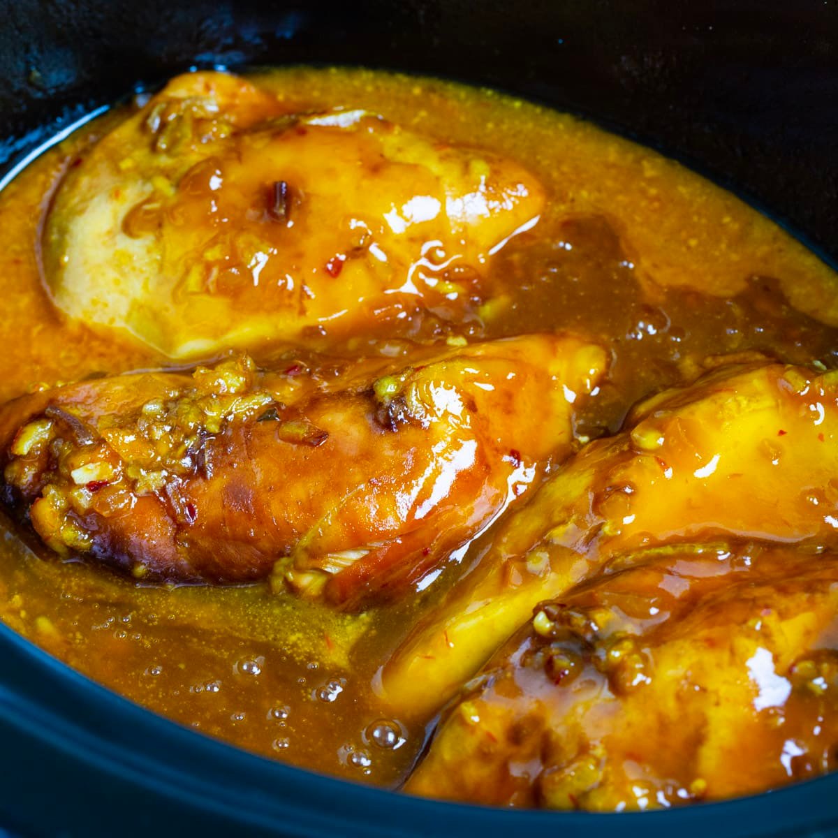 Slow Cooker Orange Chicken in a black crockpot.