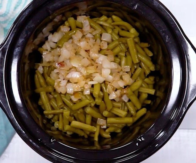 Adding onions to slow cooker.