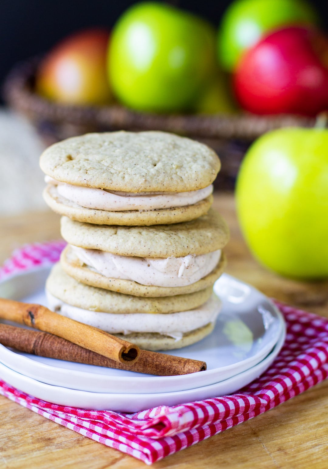 Apple Pie Whoopie Pies stacked on a small plate.