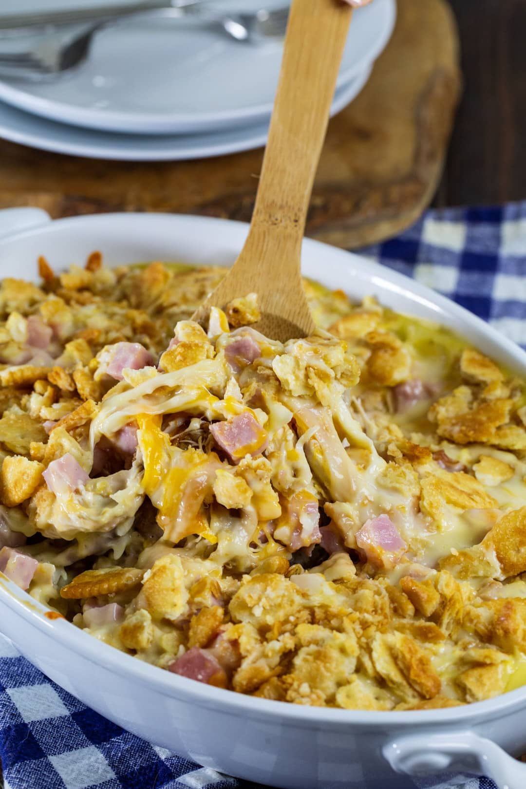 Wooden spoon scooping up   casserole.