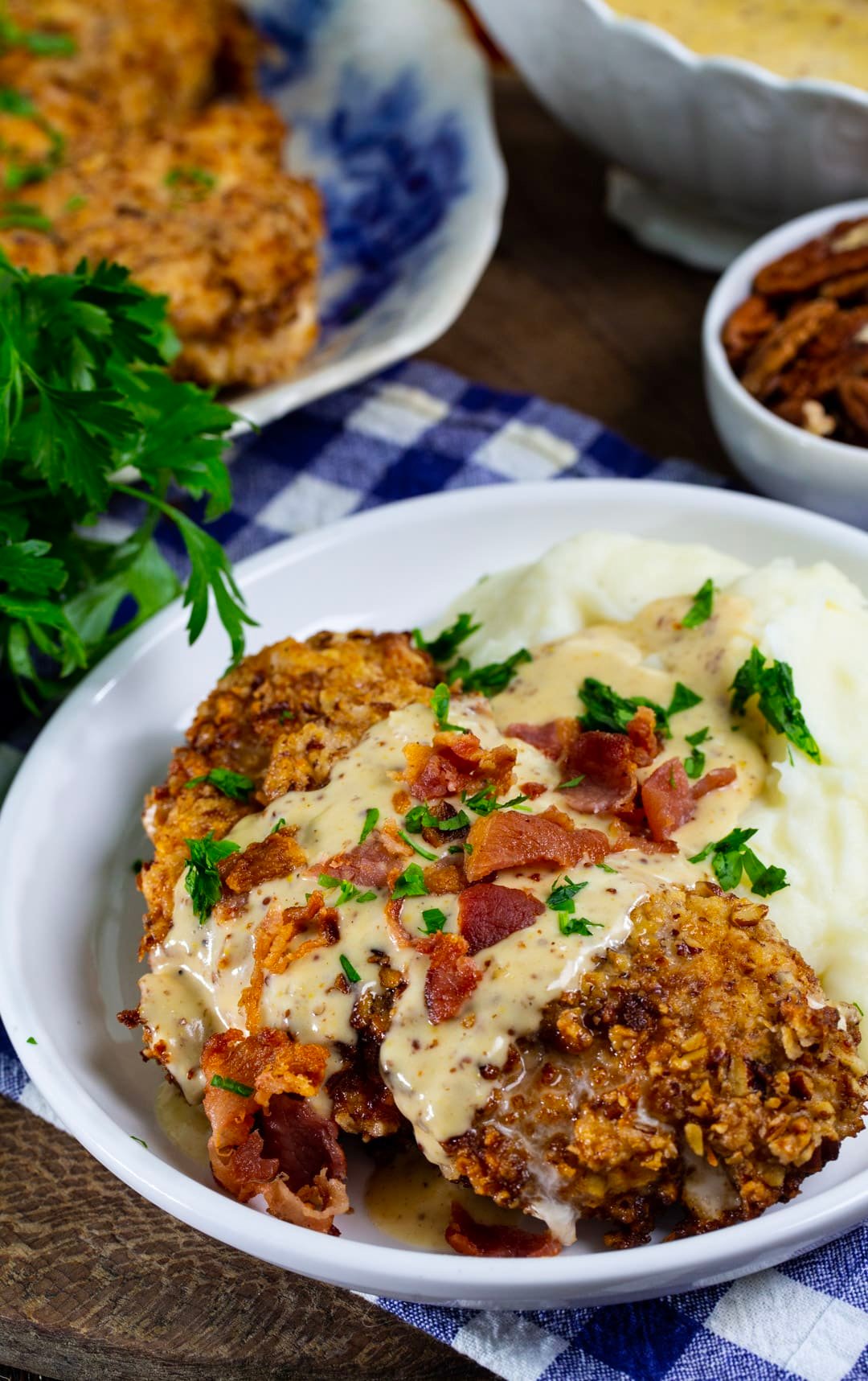 Pecan Chicken in Bourbon Maple Cream Gravy on a plate with mashed potatoes.