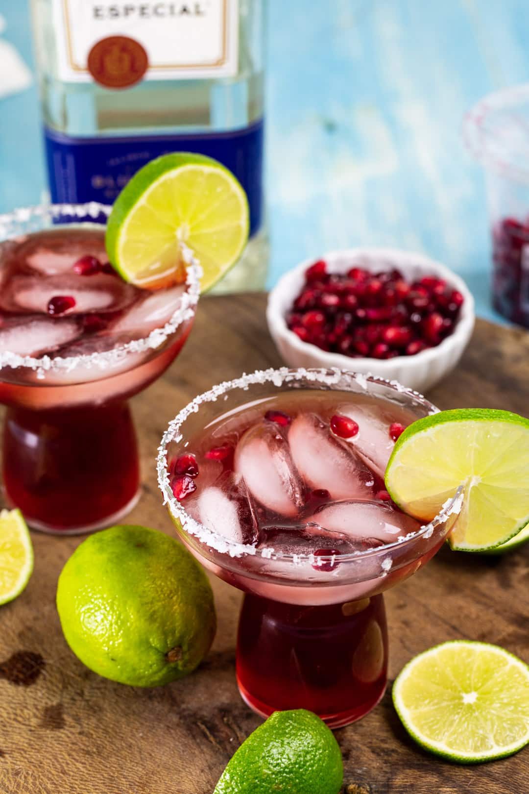 Two Pomegranate Margaritas in margarita glasses.