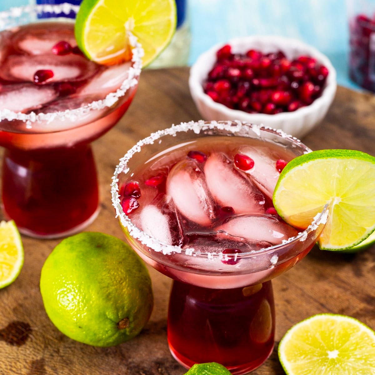 Pomegranate Margarita in a glass with fresh lime slice.