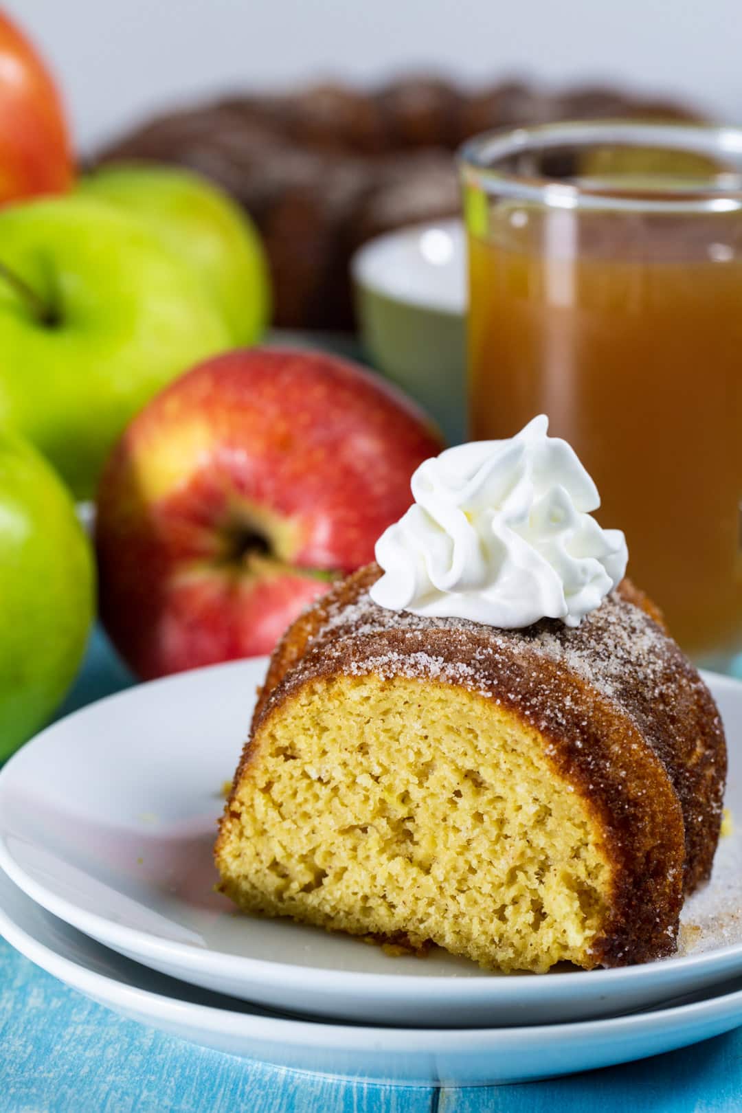 Slice of bundt cake topped with whipped cream.