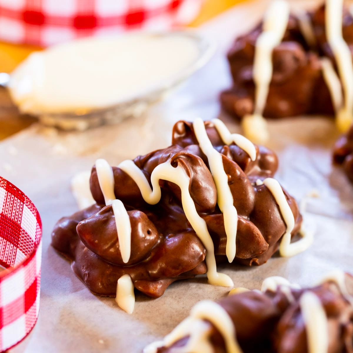 Crock Pot Nut Clusters with white chocolate drizzle.