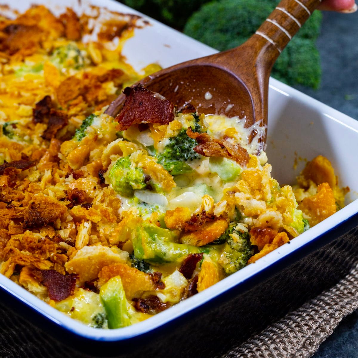 Spoon scooping Loaded Broccoli Casserole out of baking dish.