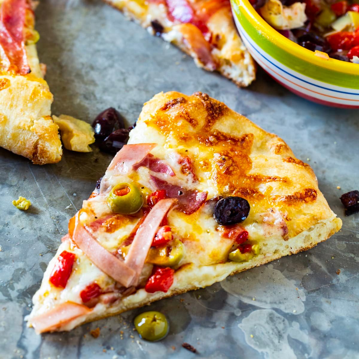 Slice of Muffaletta Pizza.