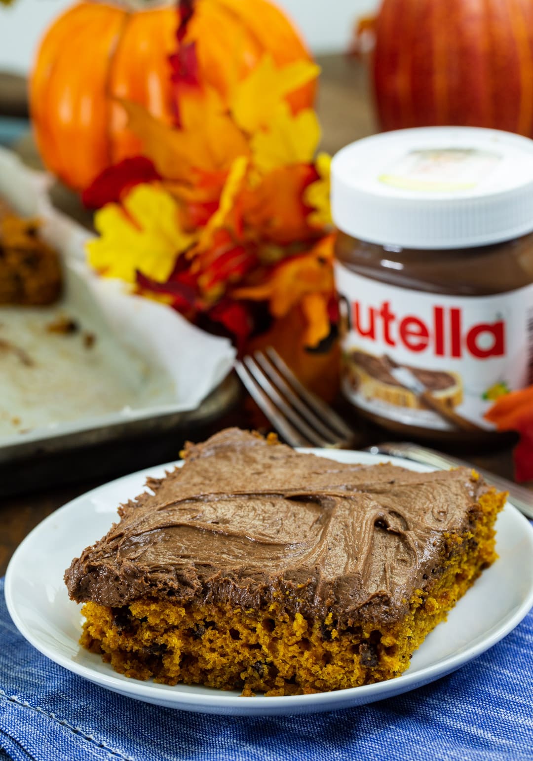 Pumpkin Sheet Cake with Nutella Cream Cheese Frosting slice on a plate.