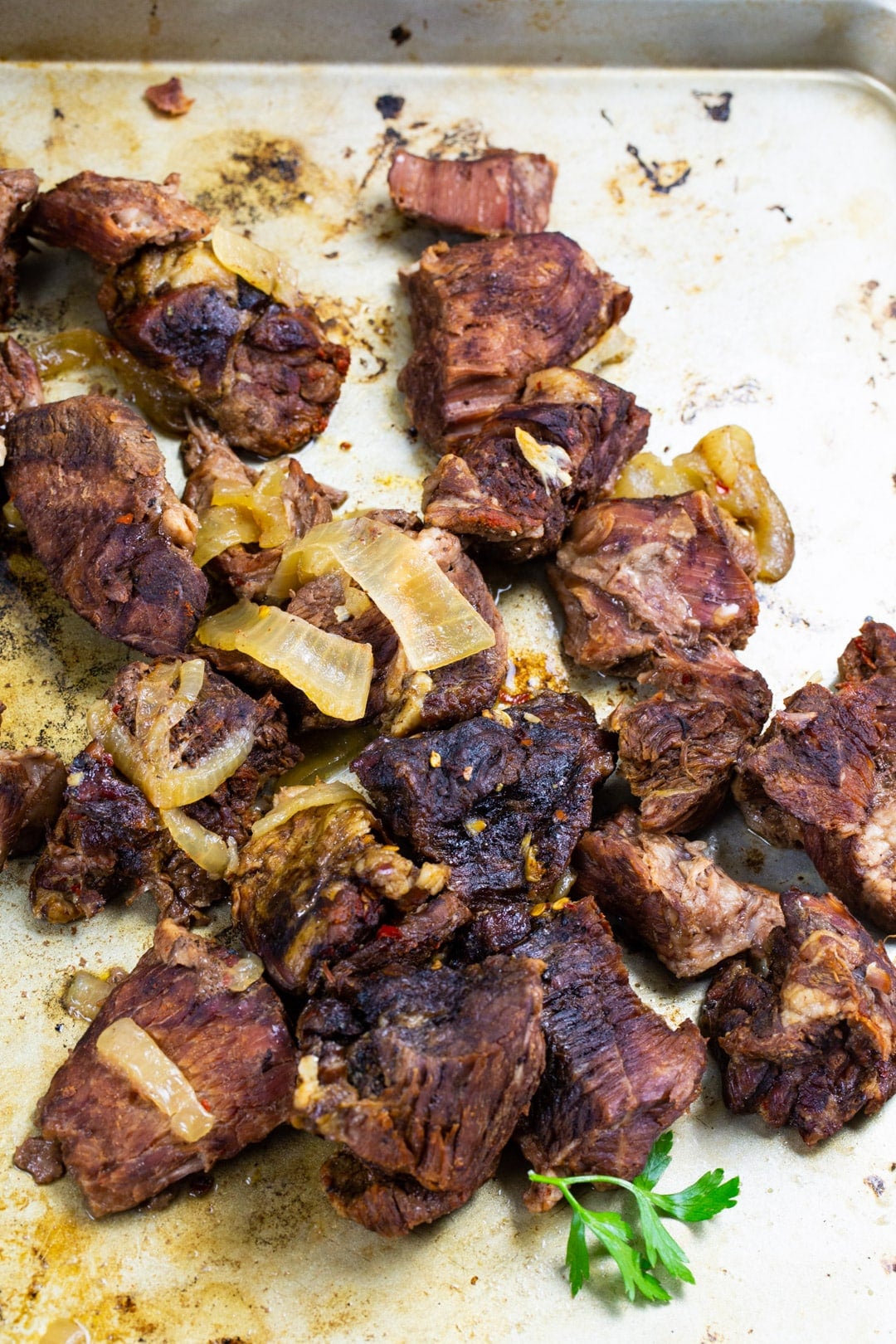 Slow cooked beef chunks on baking sheet.