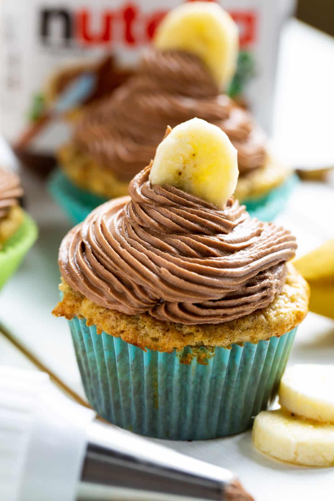 Banana Cupcakes with Nutella Frosting topped with a banana slice.