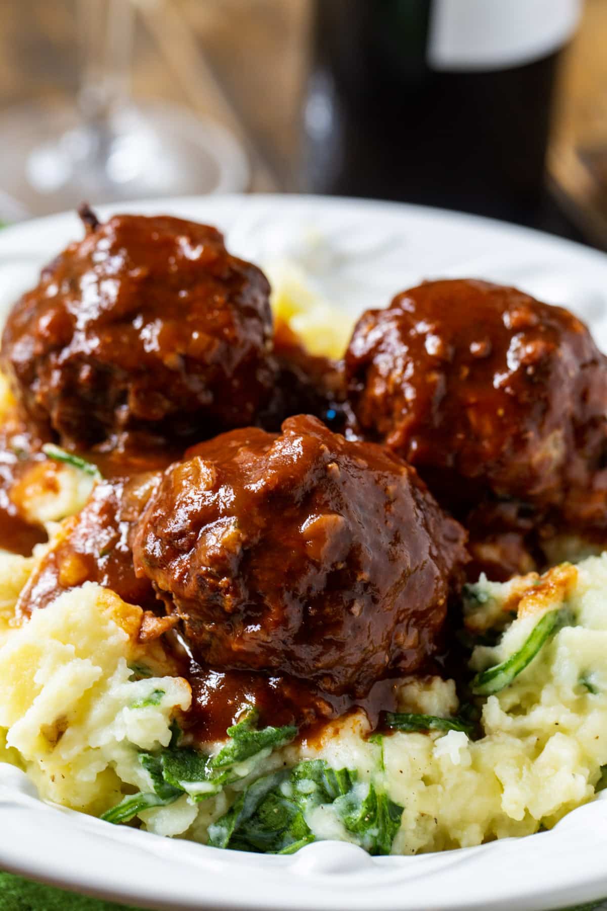 Three meatballs over mashed potatoes.