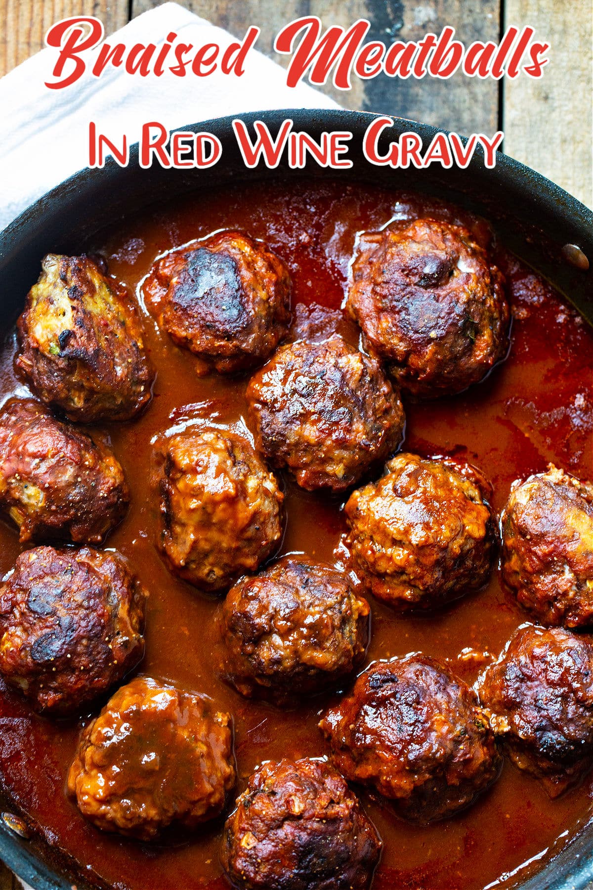 Braised Meatballs in Red Wine Gravy in a skillet.