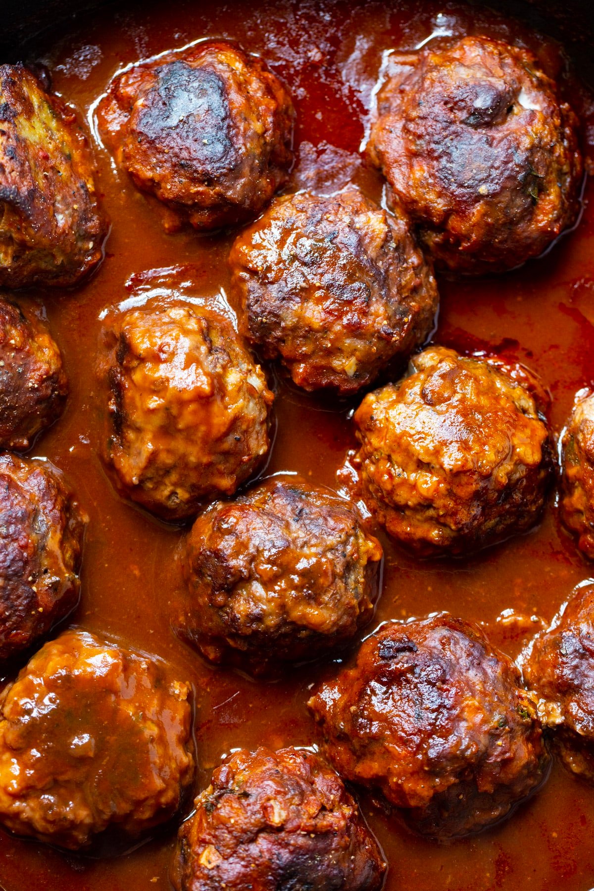 Braised Meatballs in Red Wine Gravy in a skillet.