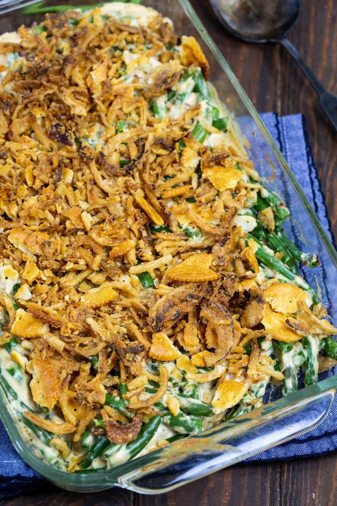 Cream Cheese Green Bean Casserole topped with French-fried onions and Ritz Cracker crumbs.
