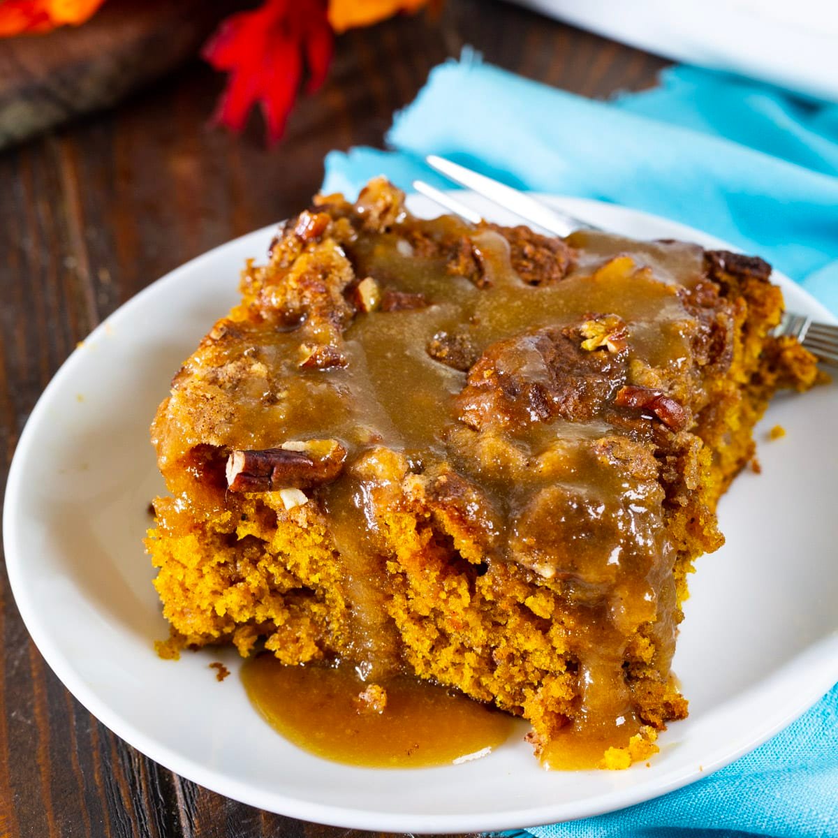 Piece of Pumpkin Coffee Cake with Brown Sugar Glaze on a small plate.