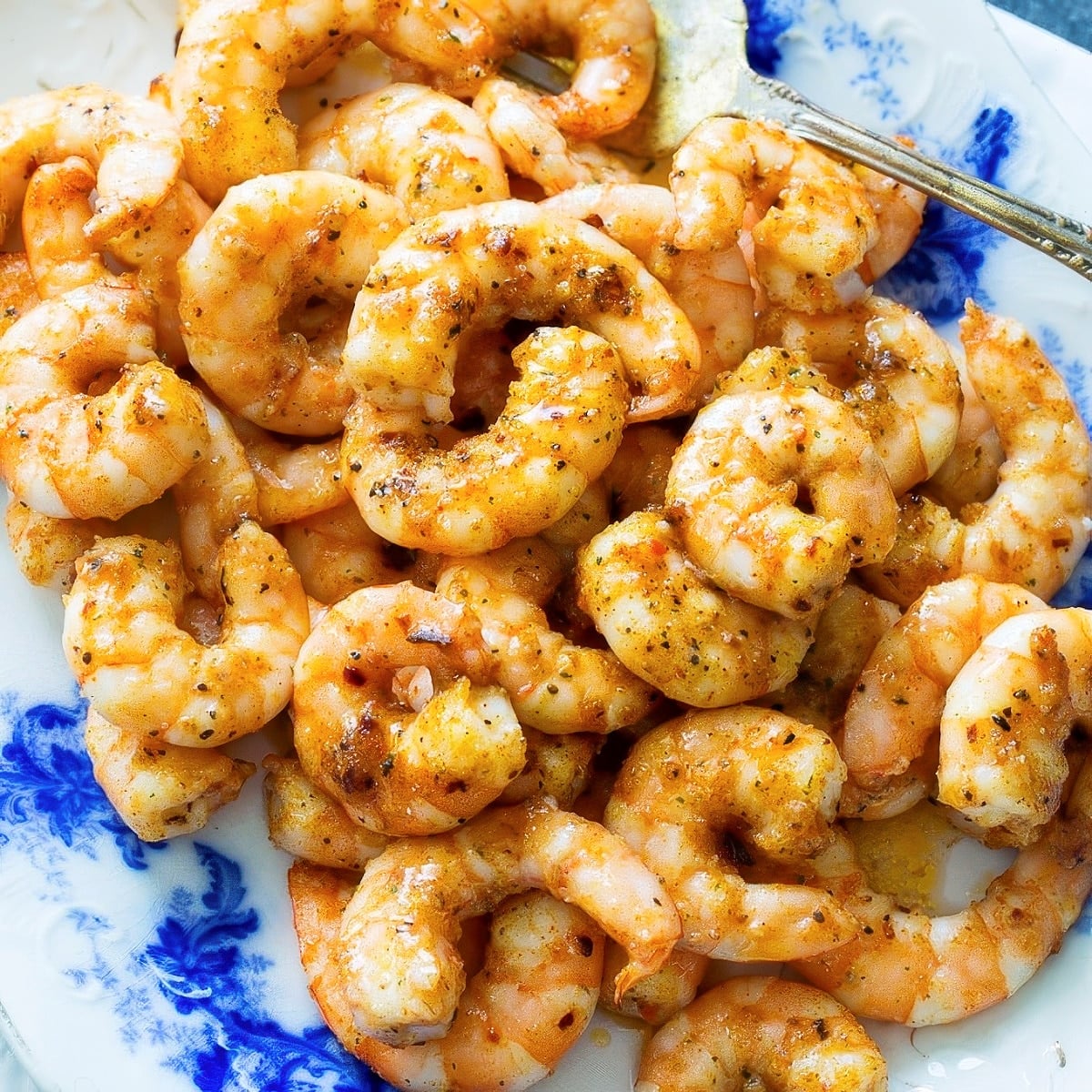 Spicy Party Shrimp on a blue and white serving dish.