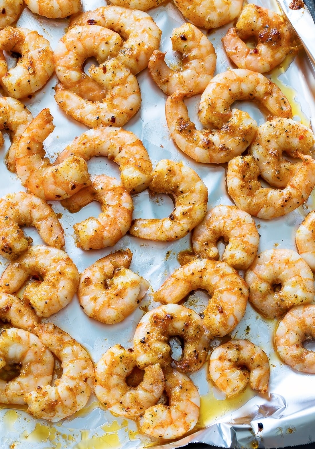 Easy Party Shrimp on a baking sheet lined with aluminum foil.