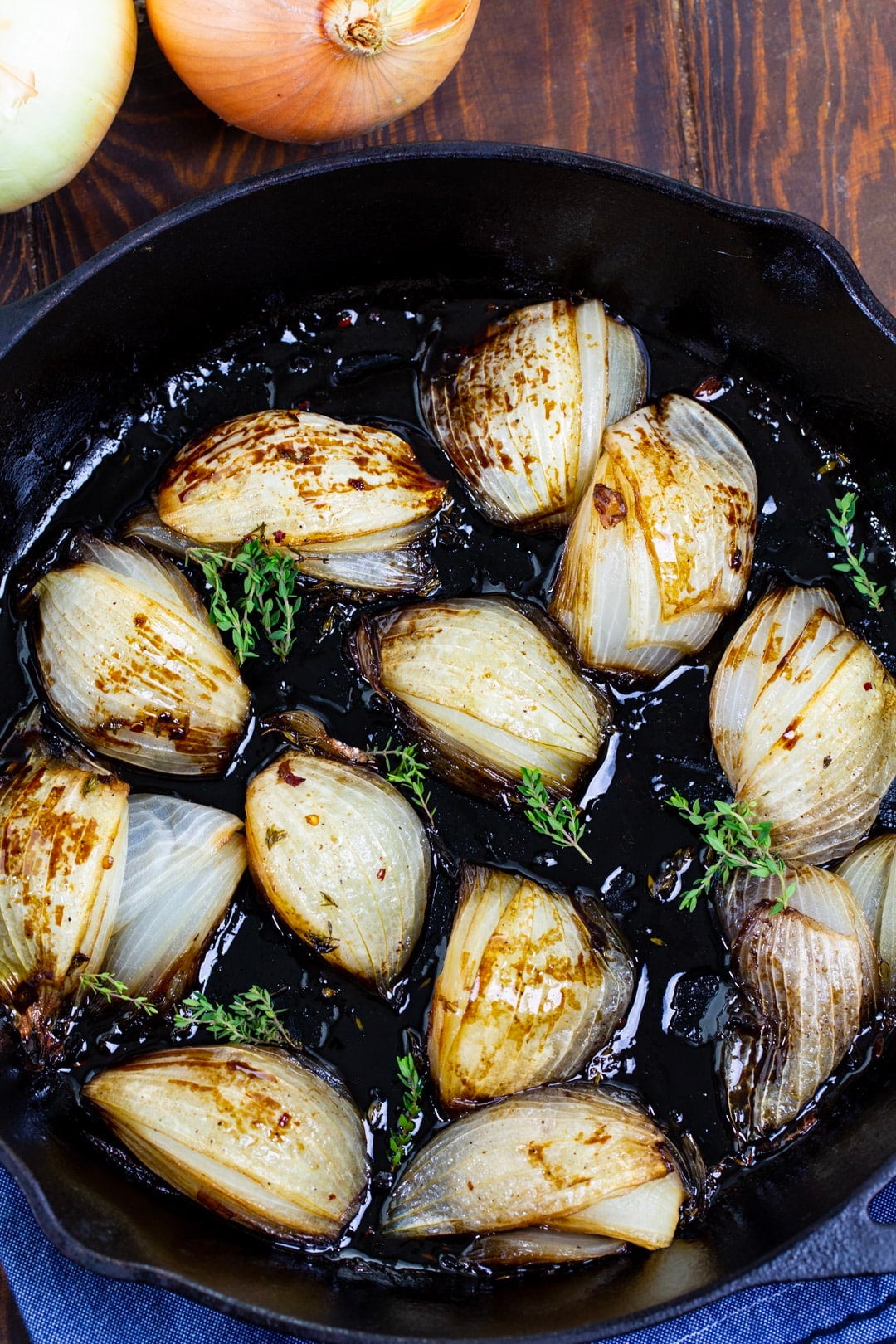 Onions with balsamic glaze in cast iron pan.