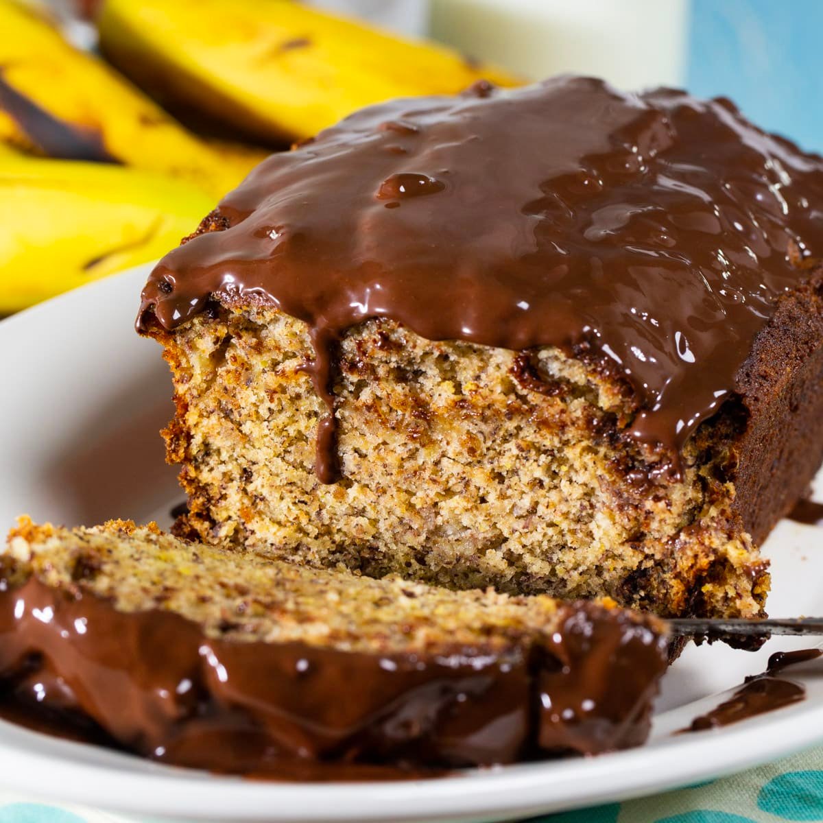 Banana Bread with Chocolate Glaze with a portion    cut.