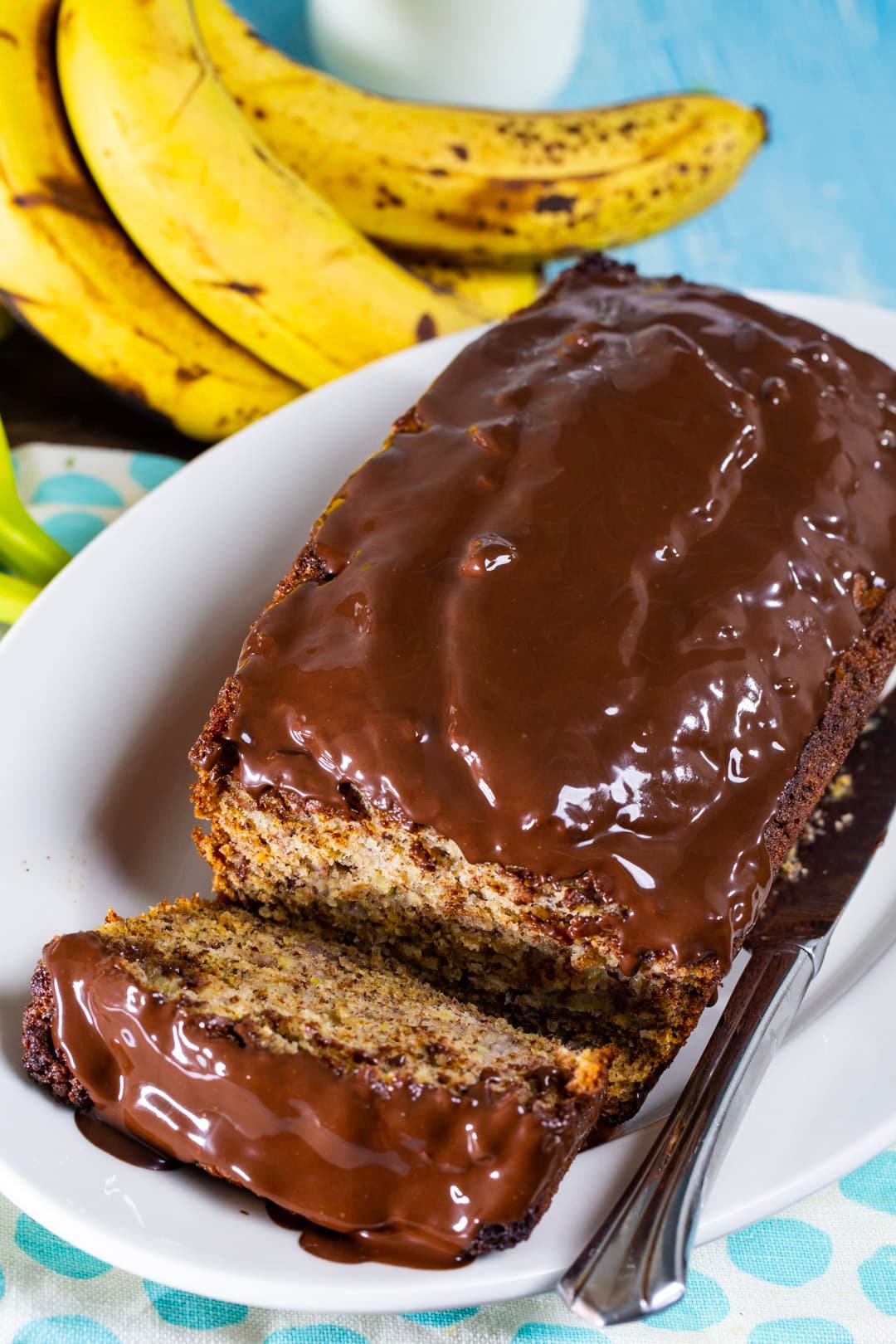 Banana Bread with Chocolate Glaze on serving plate.