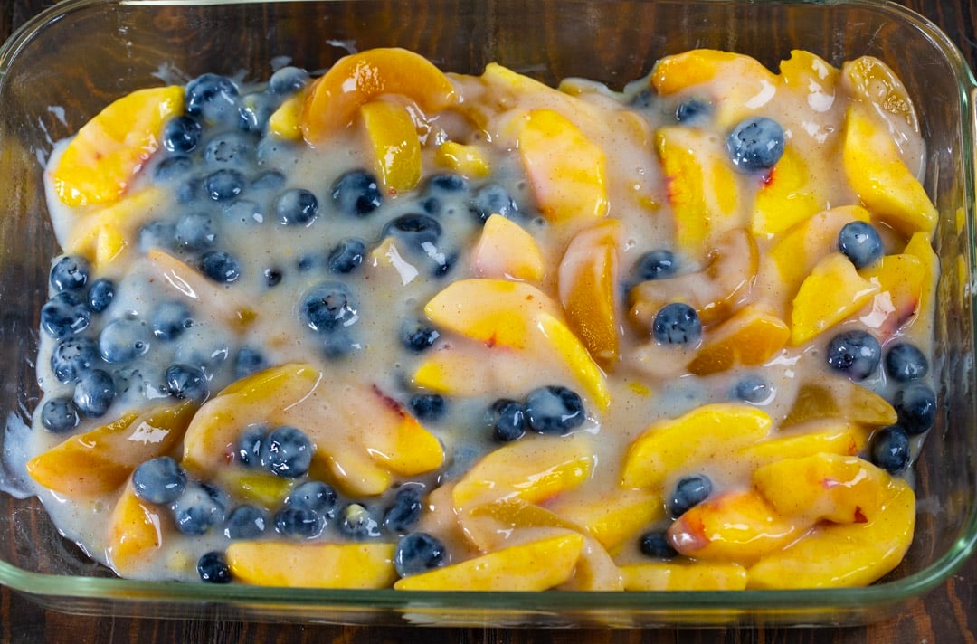 Blueberries and peaches in baking dish.