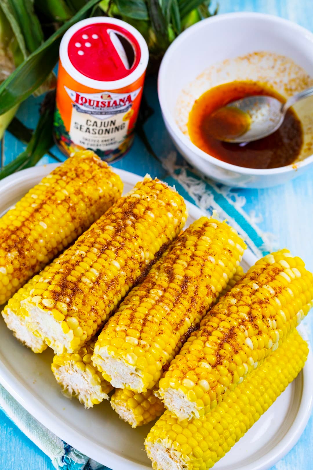 Corn on the cob covered with cajun butter.