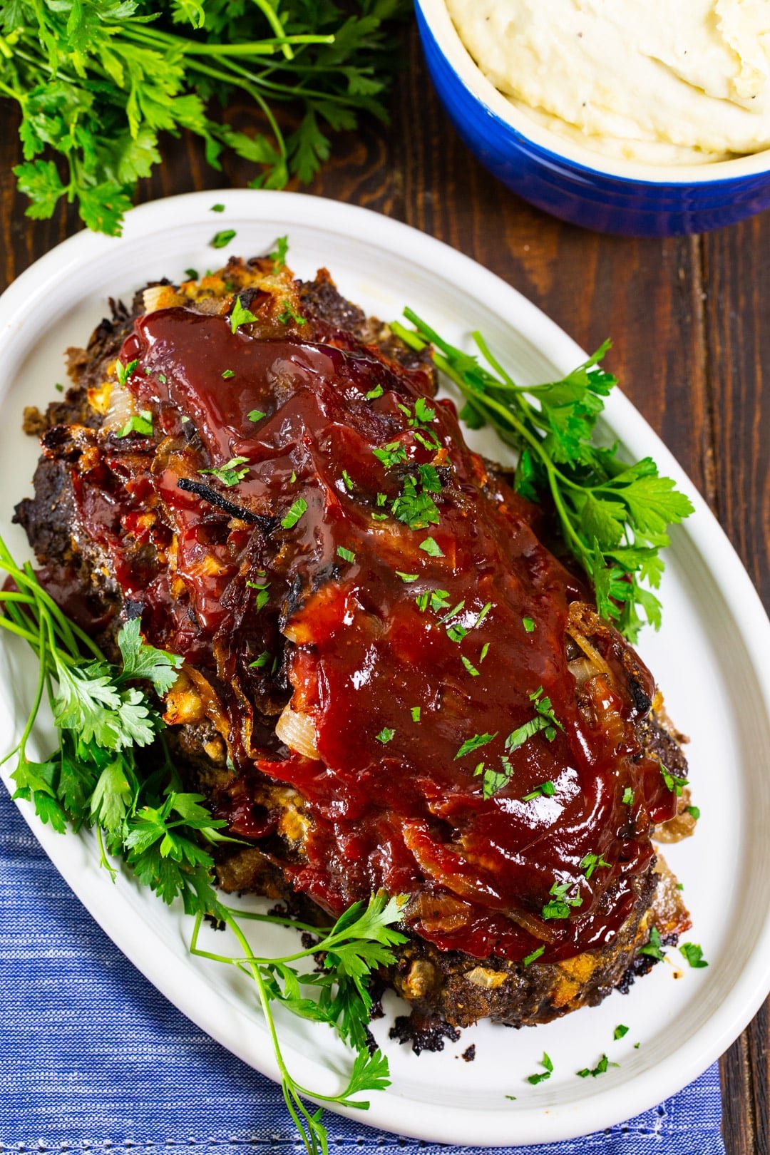 Caramelized Onion Meatloaf on serving platter with parsley.